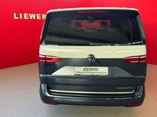 VW Multivan Business ÜH eHybrid 180 kW 4M in Candyweiß / Starlight Blue Metallic